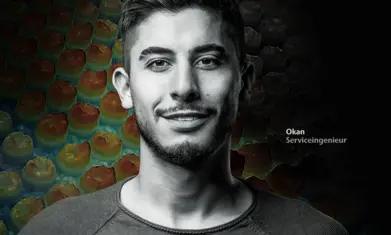 Confident young service engineer Okan smiling with an abstract textured background, representing expert technical support.