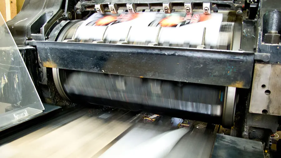 High-speed industrial printing press producing continuous sheets with rapid paper feed and precise sheet alignment.